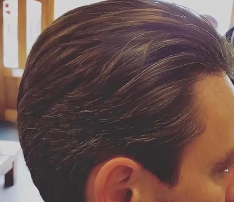 Side view of a swept-back men’s haircut
